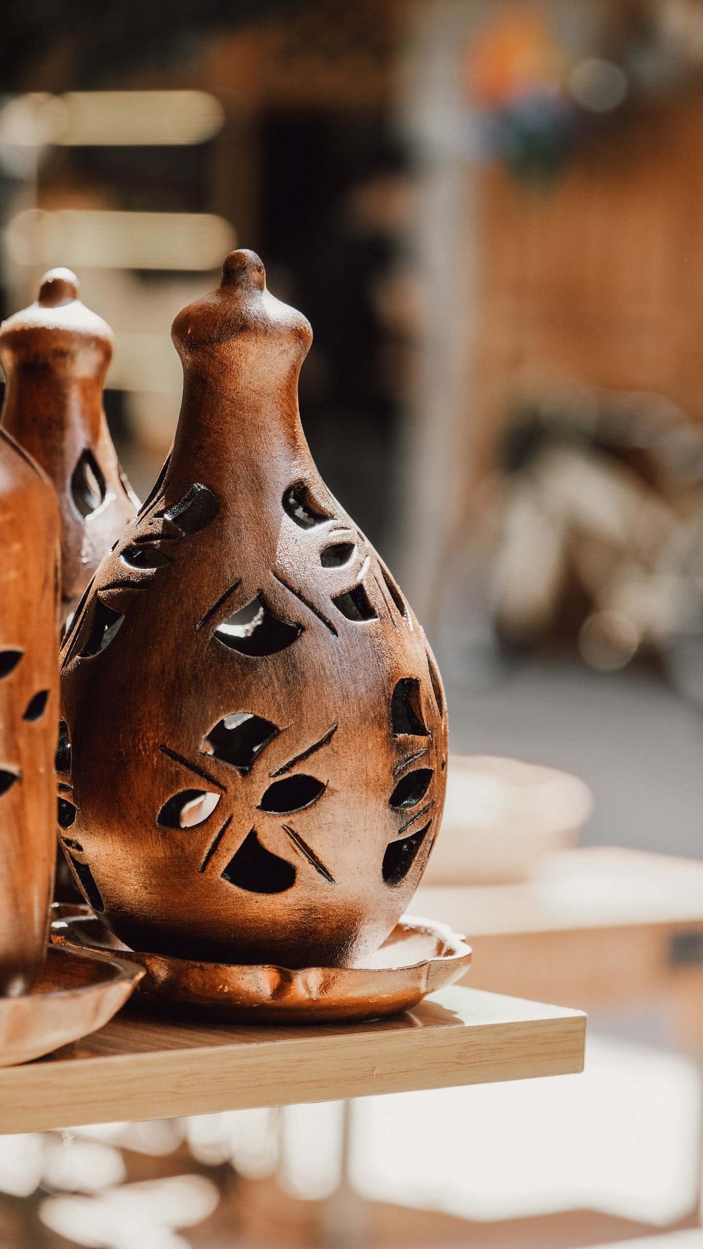 Beautifully carved wooden candle holder showcasing intricate artistry and traditional craftwork.